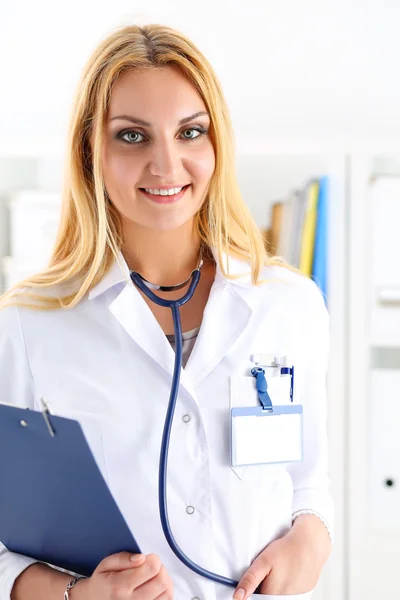 Beautiful smiling female doctor hold clipboard pad