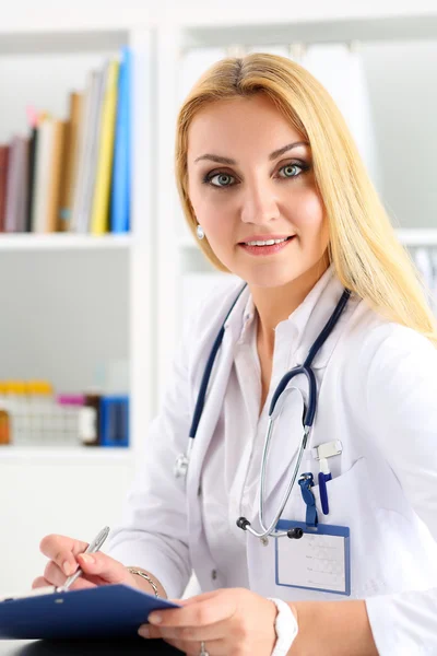 V Beautiful smiling female doctor hold clipboard pad