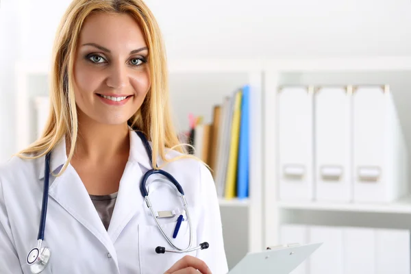 Beautiful smiling female doctor hold clipboard pad