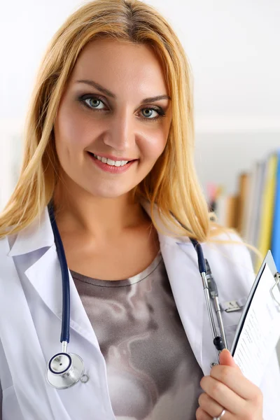 Beautiful smiling female doctor hold clipboard pad