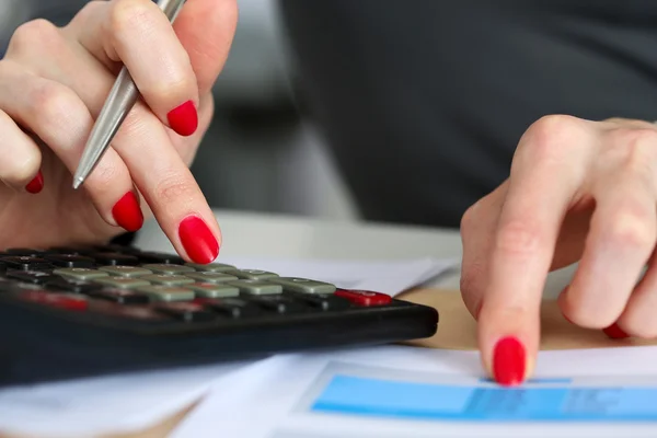 Hand of businesswoman point finger to financial table