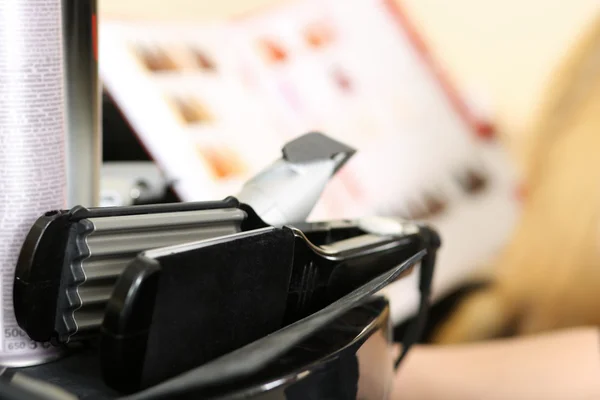 Curling tongs lying on table closeup