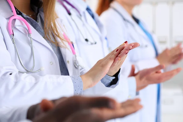 Group of doctors clapping their hands during medical conference