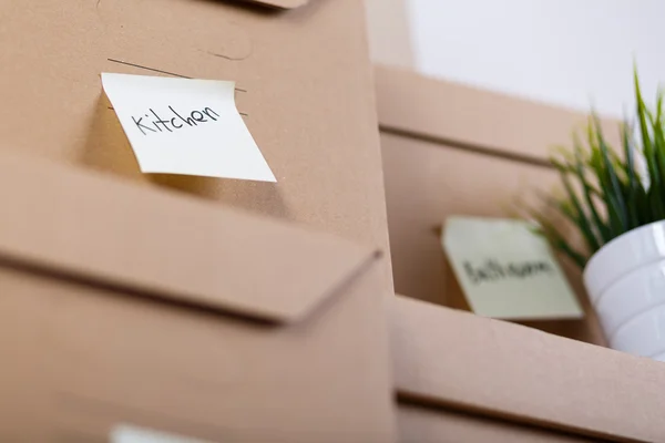 Pile of brown cardboard boxes with house or office goods