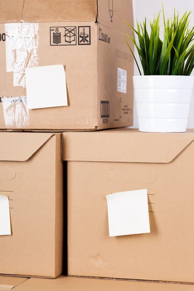 Pile of brown cardboard boxes with house or office goods