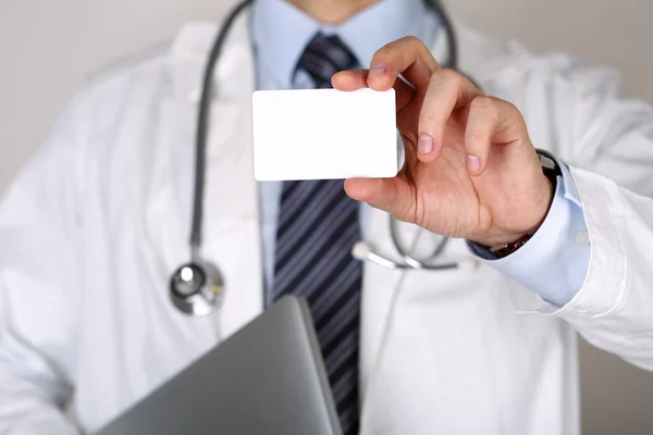 Male medicine doctor hand holding blank calling card