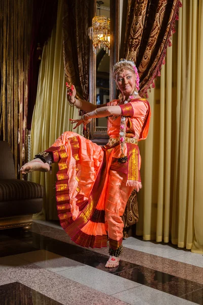 White woman is dancing in traditional indian dress