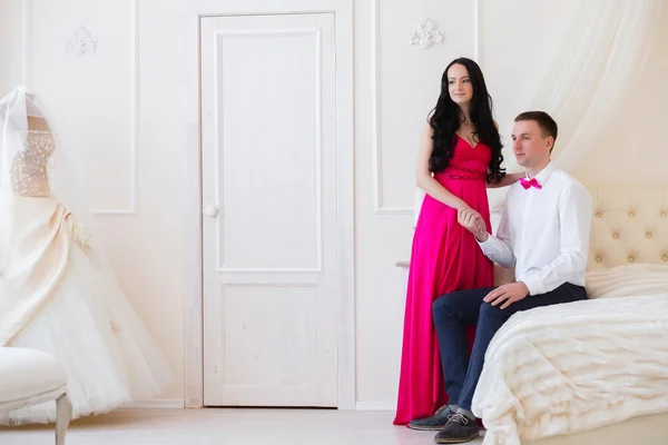 The girl in a pink dress and guy in the butterfly room for honey