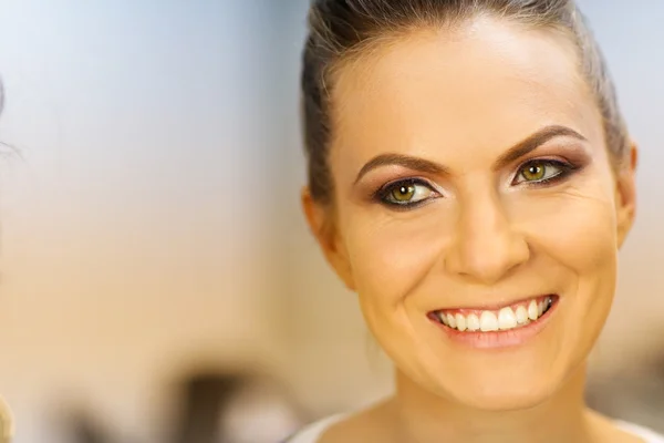 Gorgeous bride getting professional makeup on wedding day