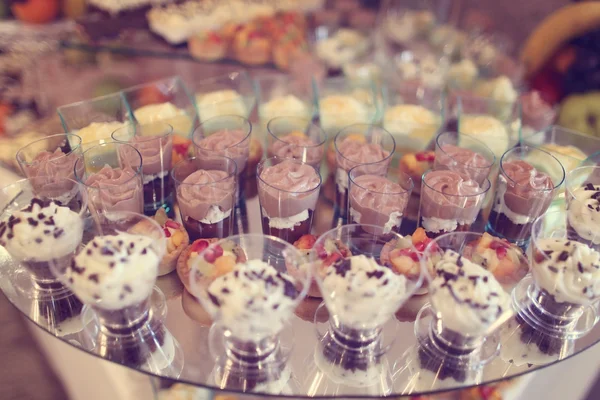 Delicious mini desserts on table