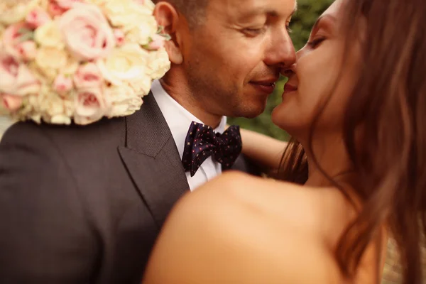 Emotional portrait of a bride and groom hugging