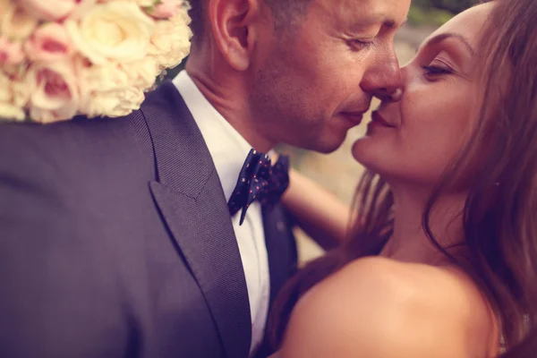 Emotional portrait of a bride and groom hugging