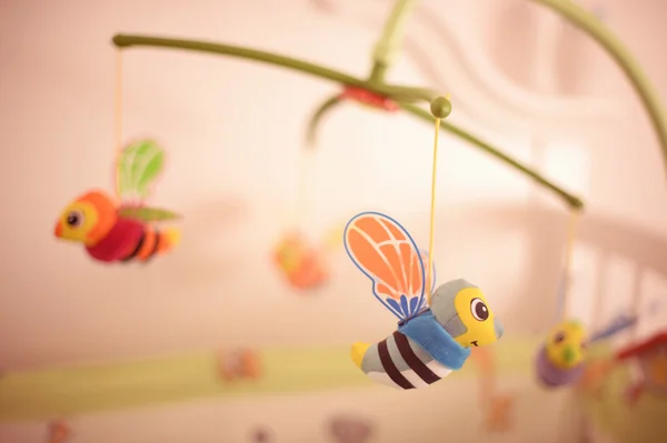 Little bee hanging above baby bed