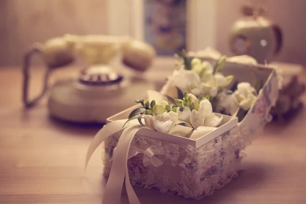 Flowers in elegant box on table