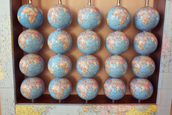 Many terrestrial globes on wall