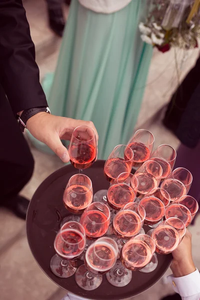 Guests serving drink at wedding