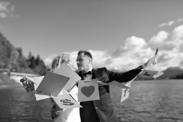 Bride and groom playing with Just Married cards