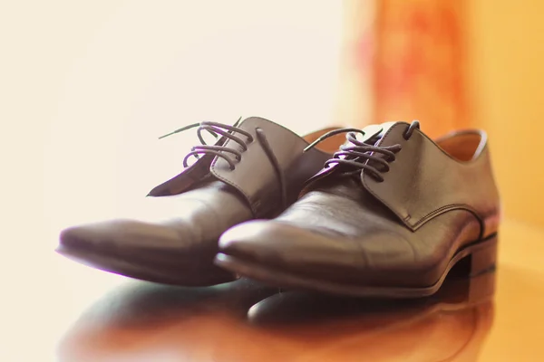 Elegant groom's shoes on wooden table