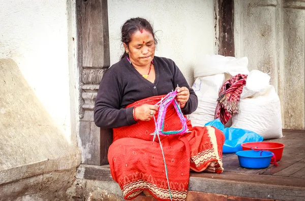 A woman is knitting souvenirs in Bhaktapur,Nepal
