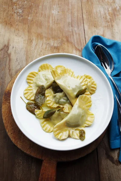 Spinach ravioli with ricotta in a bowl on a wooden table. rustic