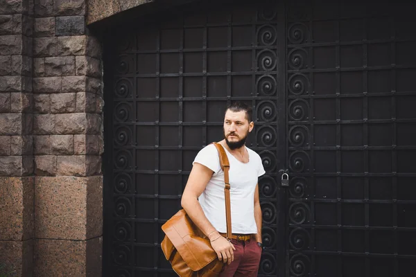 Fashion man, with leather bag and watch, casual style