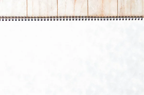 Empty blank brown front page cover of spiral bound notepad on the wooden background- Water colour effect applied