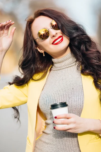 Close up beauty portrait of beauty brunette woman, nice natural glowing make up, holding cup with her morning coffee, trendy jewelry, cafe, hot beverage, enjoy.