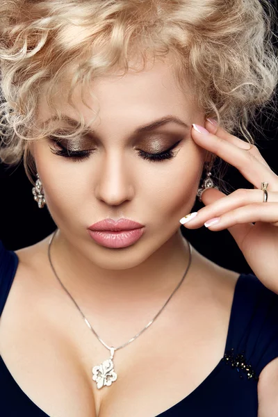 Spa, beauty, skincare, wellness and health. Glamour close-up portrait of beautiful woman model face with purity healthy skin and gold make-up and french manicure.
