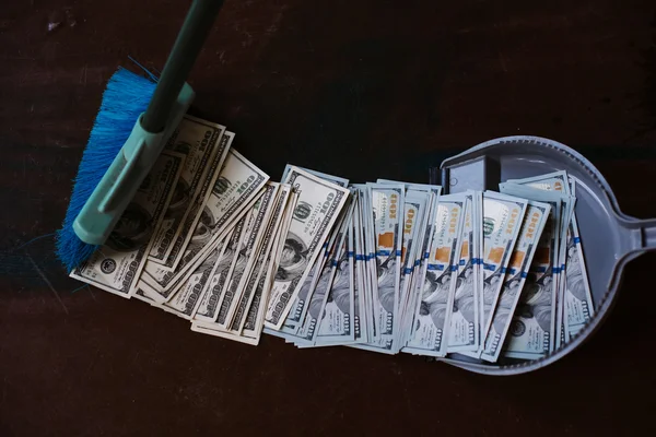 Man rakes in the money in savok. Sweep of the banknote in the trash. Clean money in the trash.