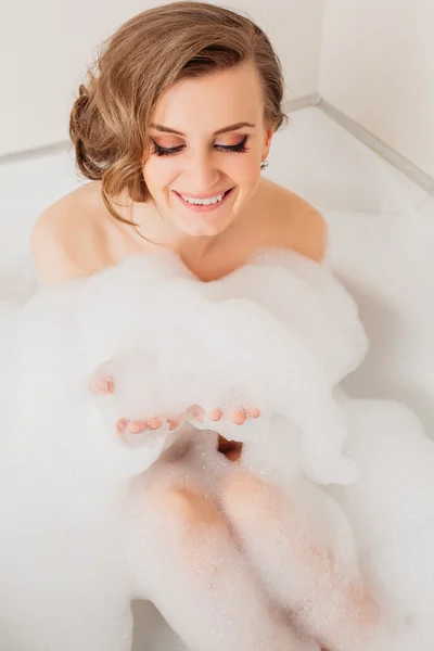 Beautiful sexy girl long hair in the bath with foam