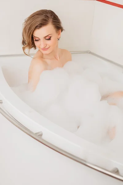 Beautiful sexy girl long hair in the bath with foam