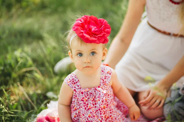Little girl child with big paint eyes in a dress on nature