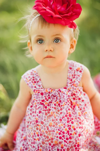 Little girl child with big paint eyes in a dress on nature