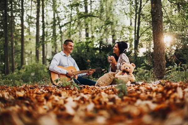 Loving young couple enjoying the outdoors, autumn, blurred