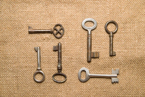A lot vintage keys to the safe on a very  old cloth