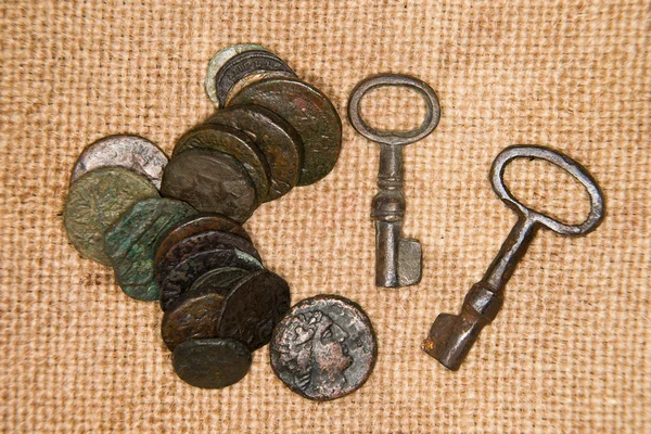 Ancient   coins with portraits of kings and keys on the old clot