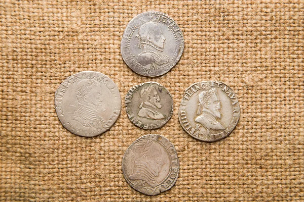 Ancient   coins with portraits of kings on the old cloth