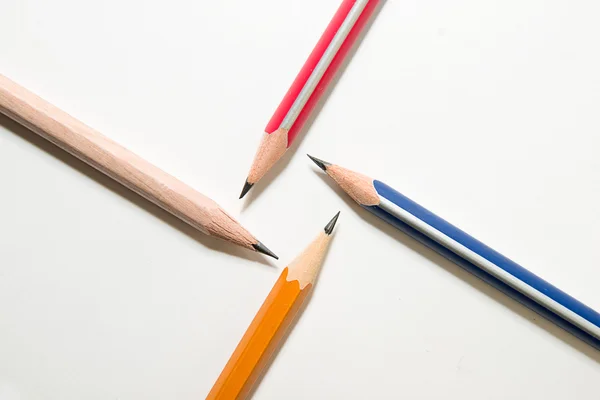Four different colors of pencil on over white