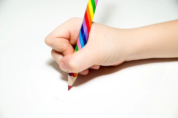 Kid\'s rigth hand holding a pencil on over white