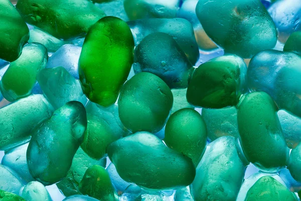 Closeup Sea stones. Abstract pattern with colored stones in green and blue tones.