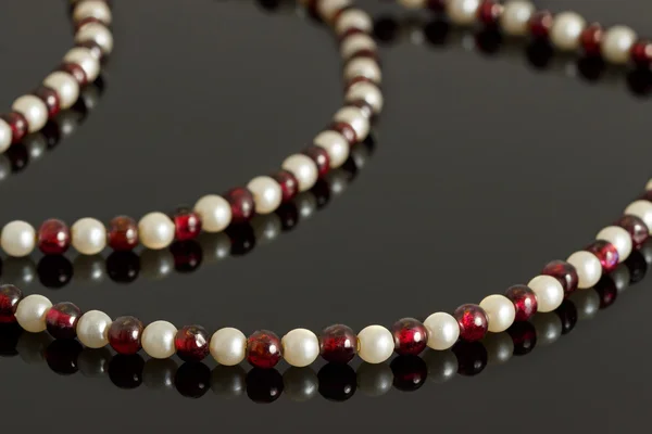 Closeup beads from garnet crystal and pink pearls