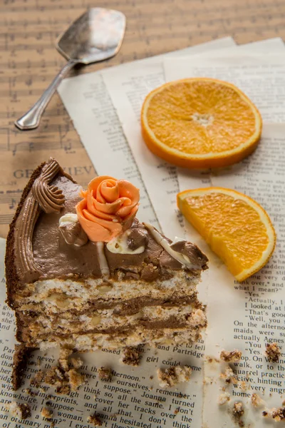 Orange cake with orange pieces on pages of books