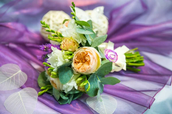 Wedding bouquet with yellow peonies on a lilac background
