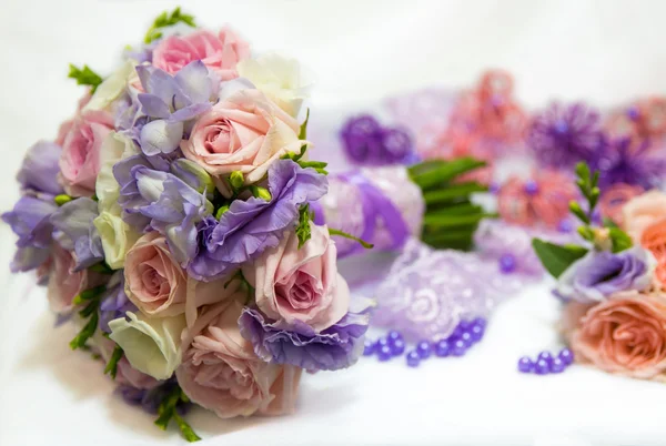 A wedding bouquet with lilac flowers and a lilac beads