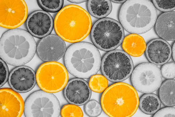 Orange oranges among black-and-white oranges