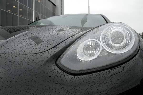 Water drops on car head lights after rain protection coating stock photos