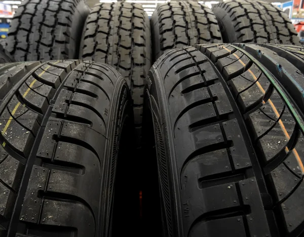 New tires on the shelf at car parts store stock photo