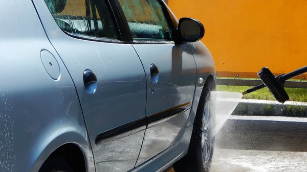 High pressure jet washer in process of car washing