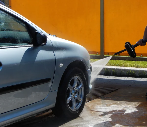 High pressure jet washer in process of car washing