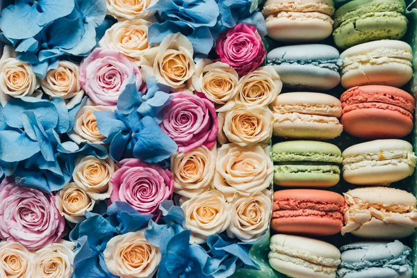 Assorted macaroon and flowers in a box